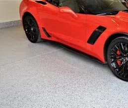 Red sports care on a full-flake mica-infused epoxy garage flooring.